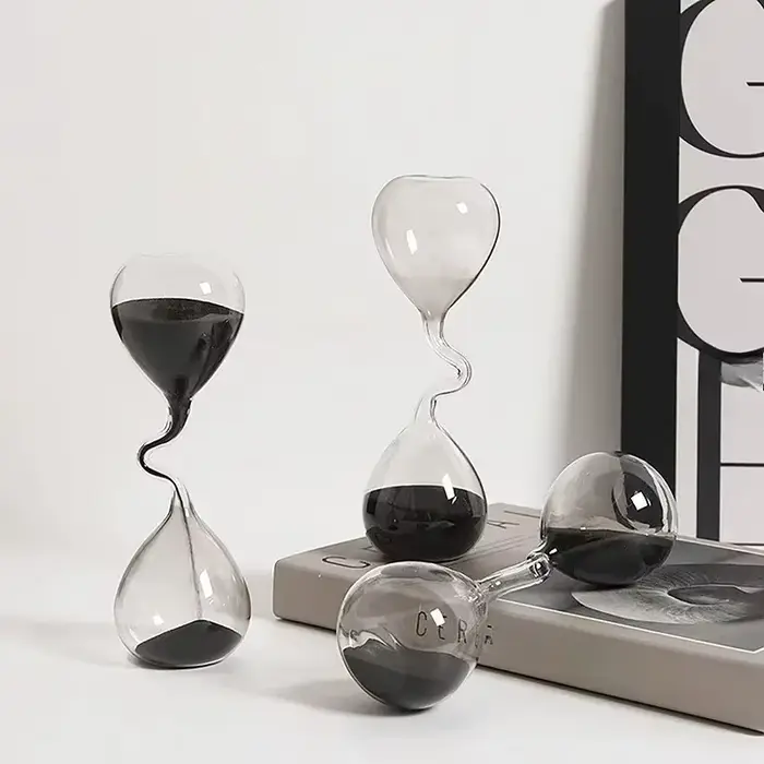 Décoration de table à manger minimaliste avec un design incurvé de style moderne noir et un artisanat en verre en forme de sablier