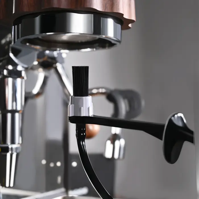 Le barista utilise un buse à vapeur d'une machine à café de qualité alimentaire résistante à la chaleur pour nettoyer